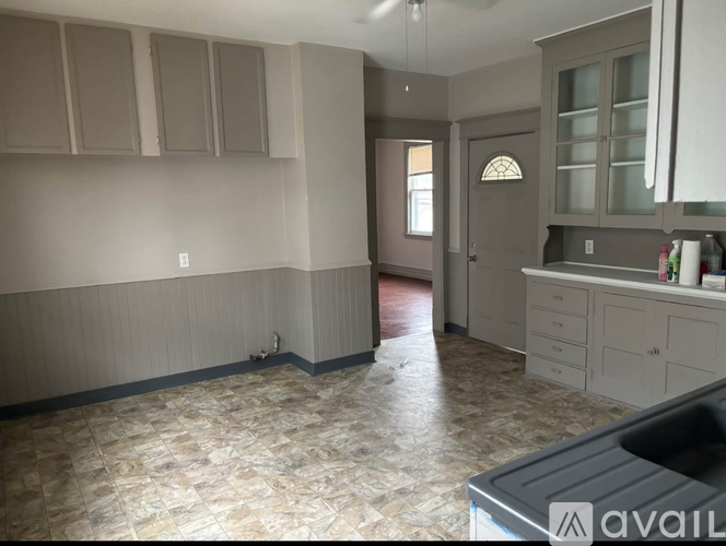 A kitchen with a tiled floor and a window.