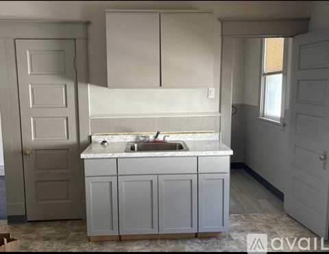 A kitchen with a sink and cabinets.