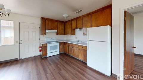 A kitchen with wooden cabinets and white appliances.