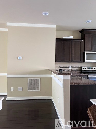 A kitchen with brown cabinets and a countertop.