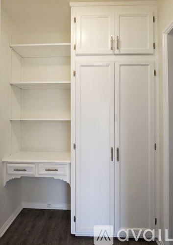 A white cabinet with two doors and two drawers is in the image.