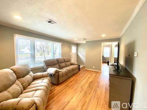 A living room with a large couch and a television.