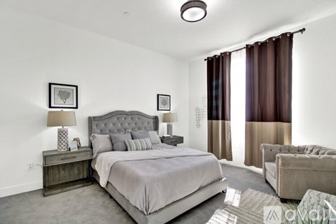 A bedroom with a large bed and a couch.