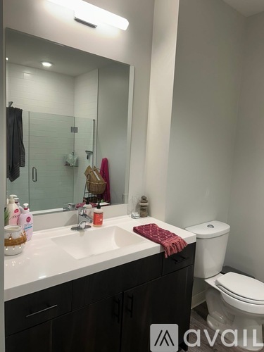 A bathroom with a white sink and toilet.