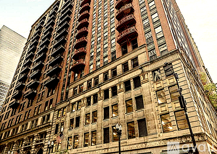 A tall building with many windows and balconies.
