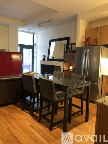 A kitchen with a table and chairs.
