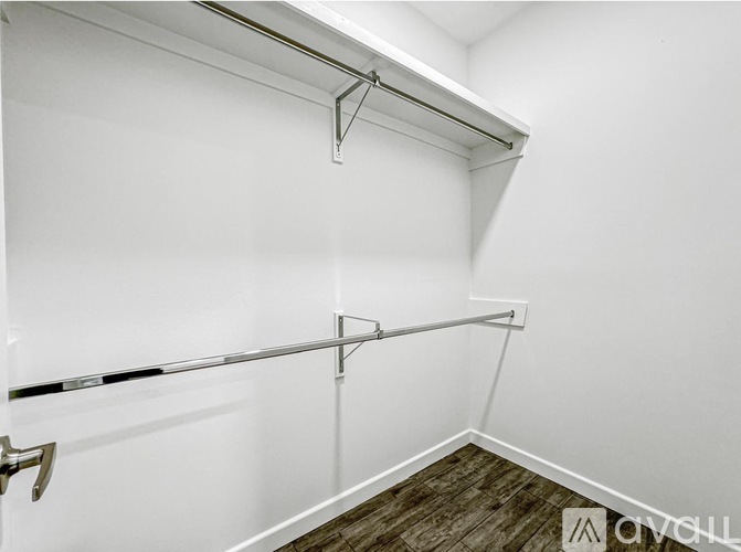 A white wall with a black line and a silver bar.