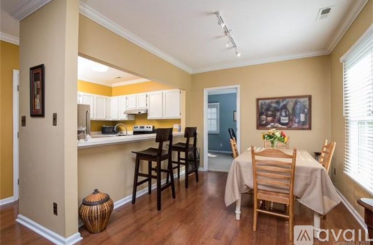 A dining room with a table set for six.