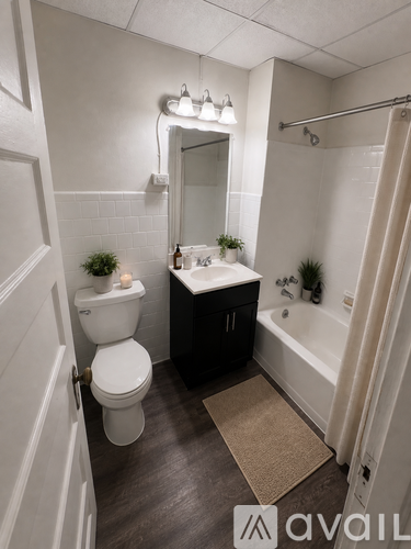 A bathroom with a toilet, sink, and bathtub.