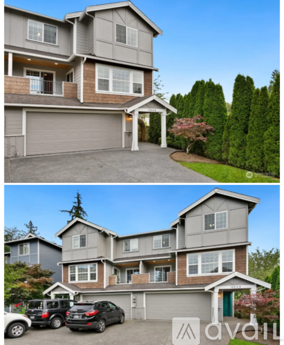 A two-story house with a garage and a driveway.