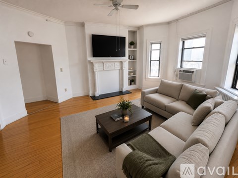 A living room with a grey couch and a coffee table.