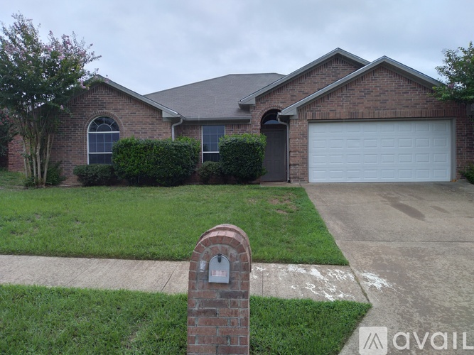 A house with a brick pillar in front of it.
