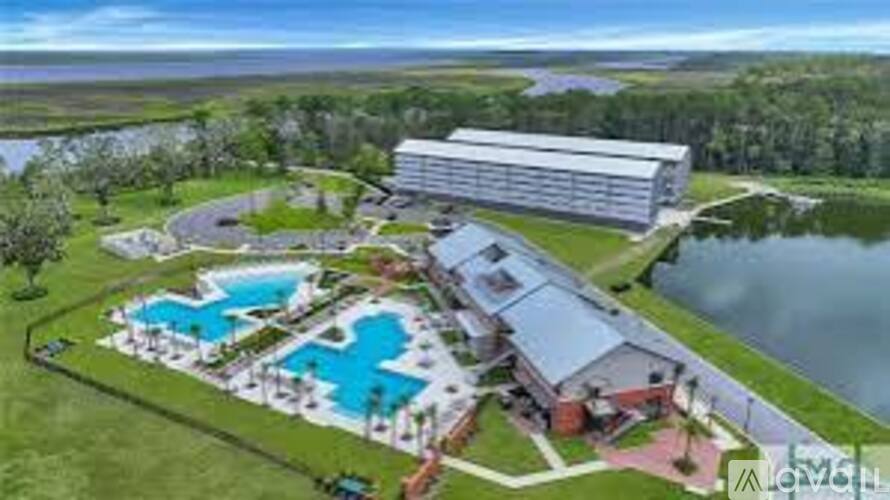 A large building with a pool in front of it.
