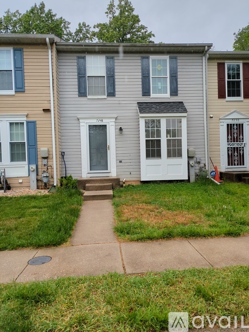 A house with a grey front door and a white front window.