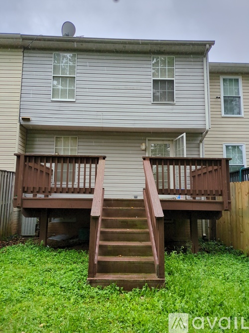 A house with a deck and stairs leading to it.