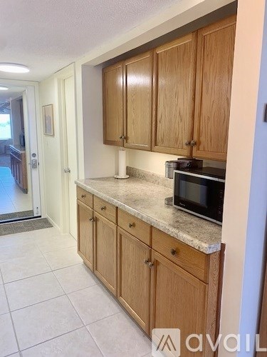 A kitchen with wooden cabinets and a granite countertop.
