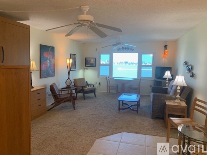 A living room with a ceiling fan and a couch.