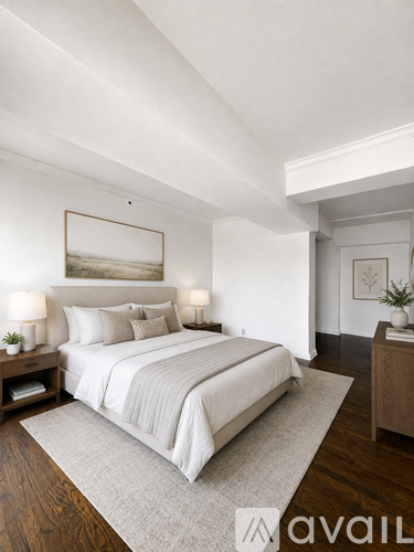 A bedroom with a large bed and a painting on the wall.
