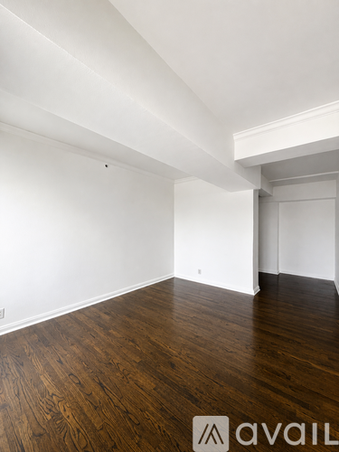 A room with wooden floors and white walls.