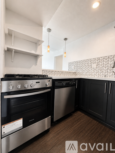 A kitchen with a stove top oven and a dishwasher.