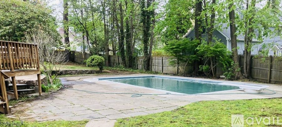 A backyard with a pool and deck.