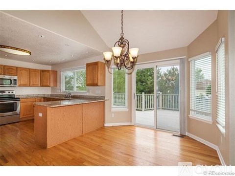 A kitchen with wooden cabinets and a large island.