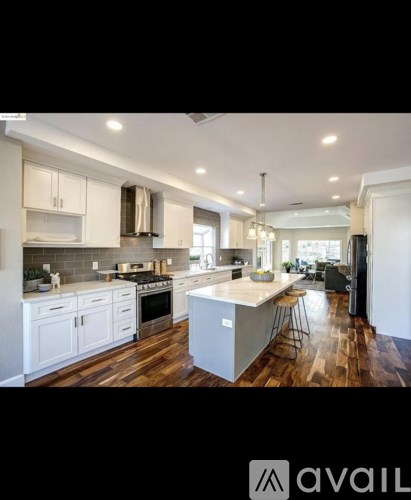 A modern kitchen with white cabinets and a central island.