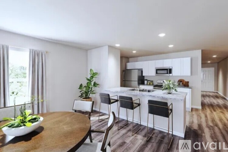 A modern kitchen with a dining table and chairs.