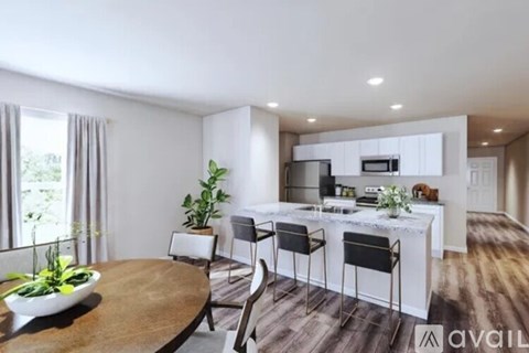 A modern kitchen with a dining table and chairs.