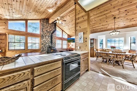 A wooden kitchen with a black stove top oven.