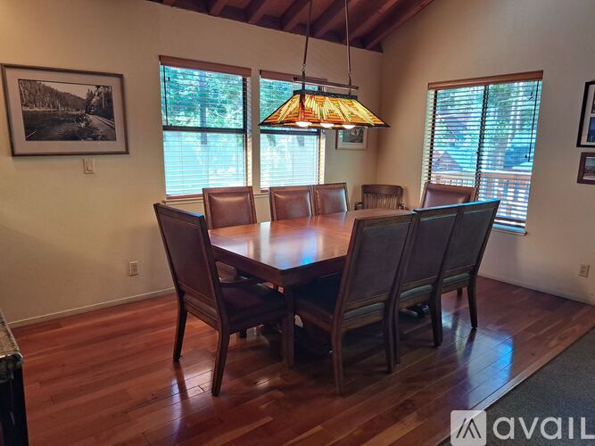 A dining room with a wooden table and chairs.