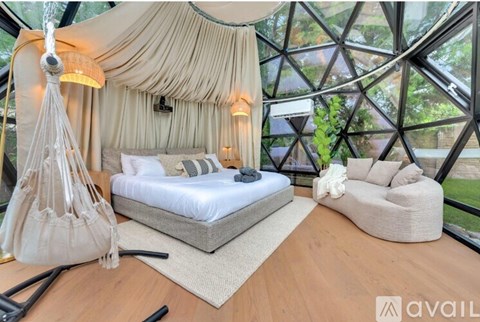 A bedroom with a canopy bed and a couch.