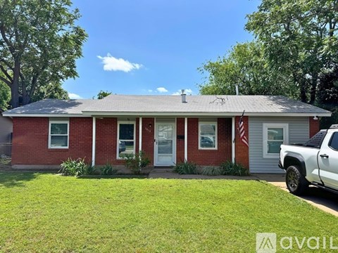 A red brick house with a white truck parked in front.