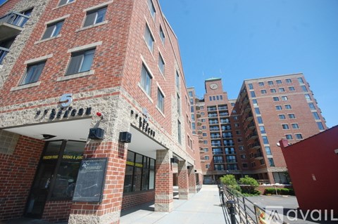 A red brick building with a sign that says "S" on it.