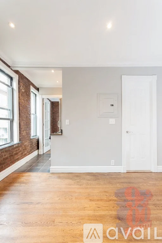 A room with wooden floors and a white door.