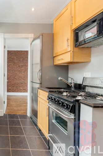A kitchen with a stove top oven and microwave.