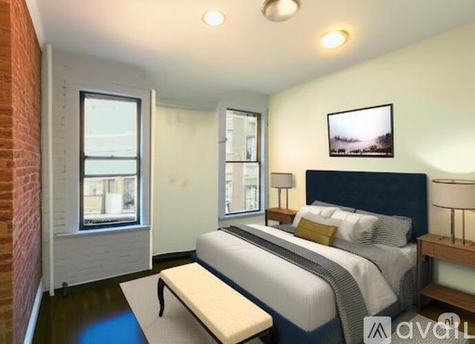A bedroom with a large bed and a window overlooking a cityscape.