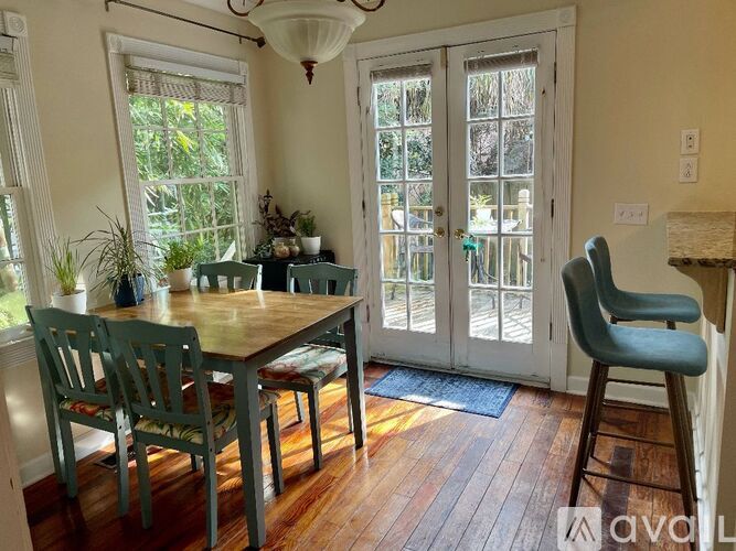 A dining room with a wooden table and chairs.