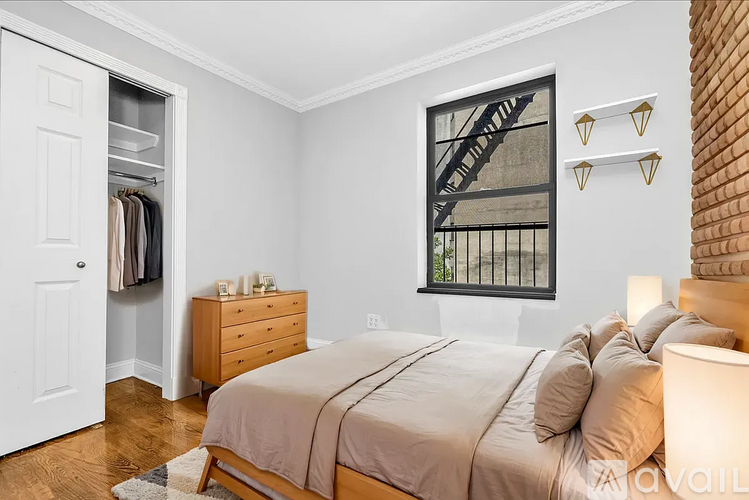 A bedroom with a large bed and a wardrobe.