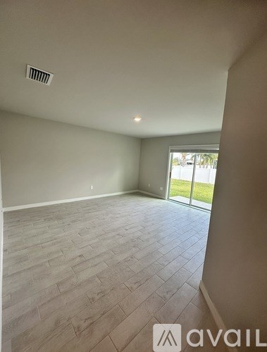 A room with a large window and a tiled floor.