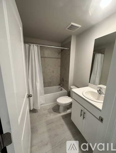 A bathroom with a toilet, sink, and shower.