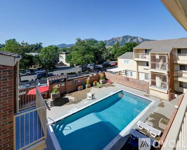 A pool in a courtyard surrounded by buildings.