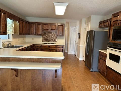 A kitchen with wooden cabinets and a white countertop.