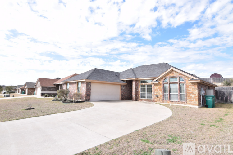 A house with a driveway and a sign that says "available".