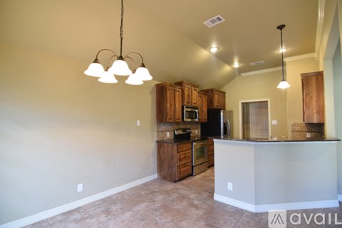 A kitchen with a white counter and wooden cabinets.