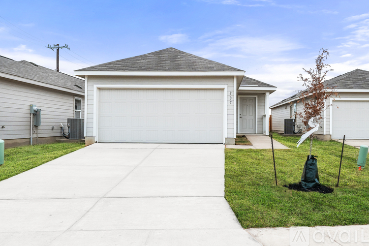 A house with a white garage door and a driveway in front.