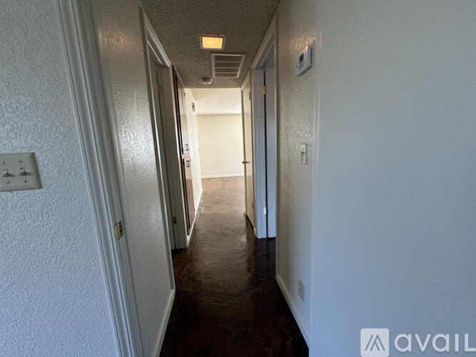 A long hallway with doors on both sides.