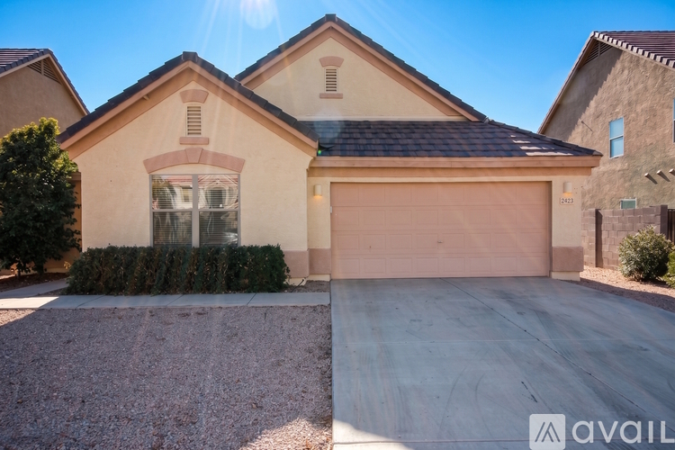 A house with a garage and a driveway in front.
