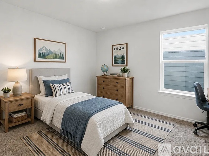 A bedroom with a bed, a nightstand, a chair, and a window.