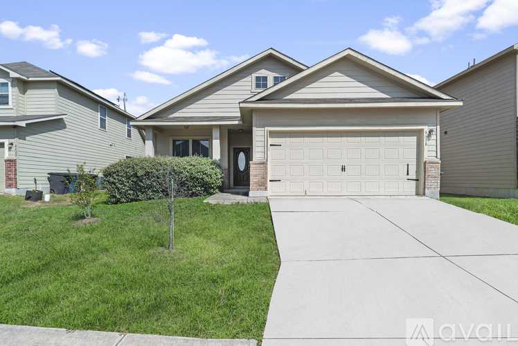 A house with a garage and a driveway in front.